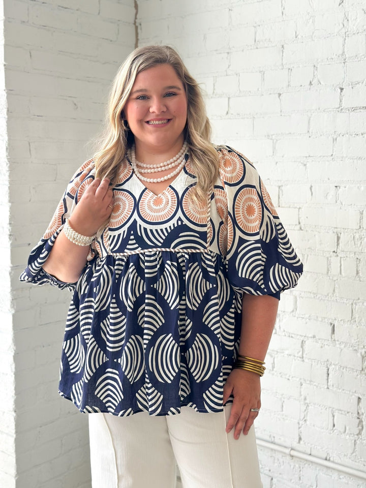 Navy printed babydoll top with a ruffled neckline