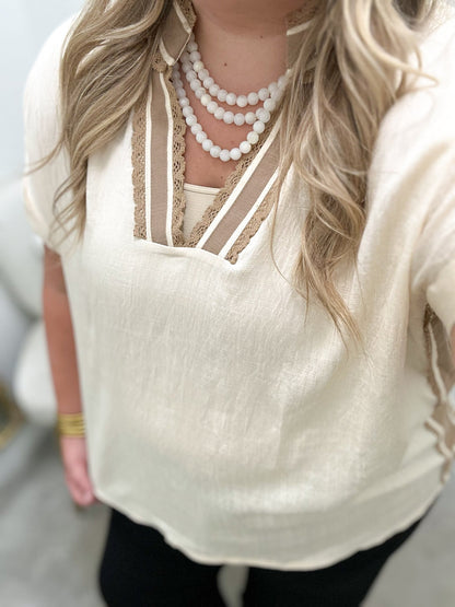 Lace trimmed natural top with a relaxed body