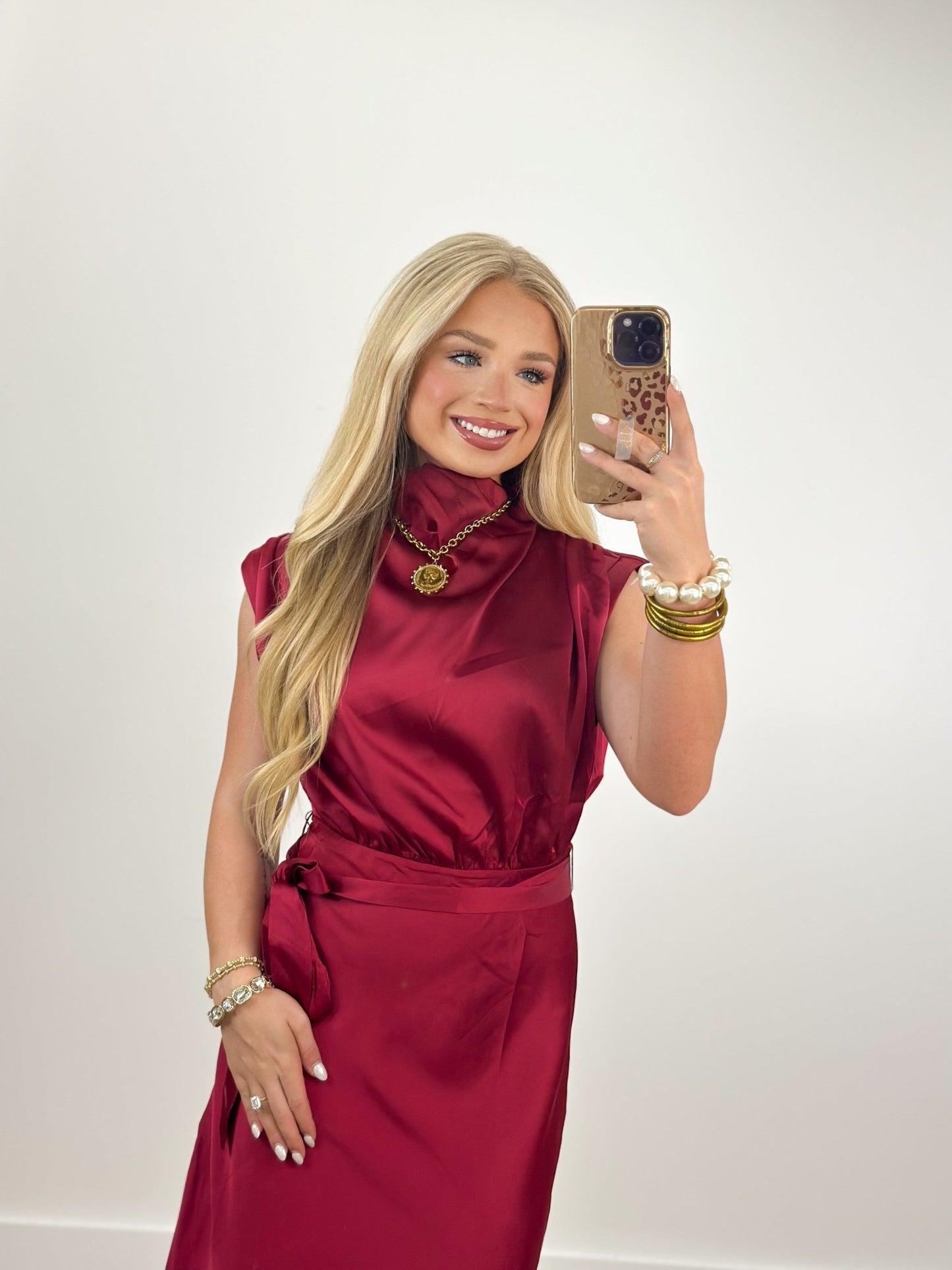 Draped cowl neckline on a burgundy sleeveless dress
