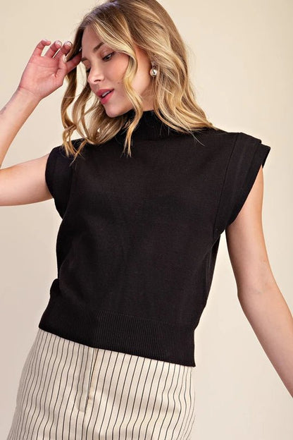 Sleeveless top with a closed high neckline