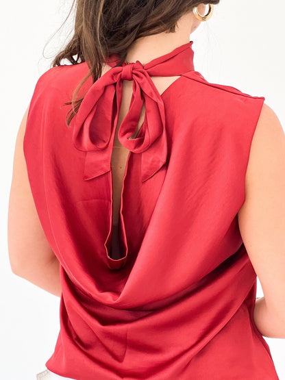 Sleeveless mock neck top in rust with a tied accent