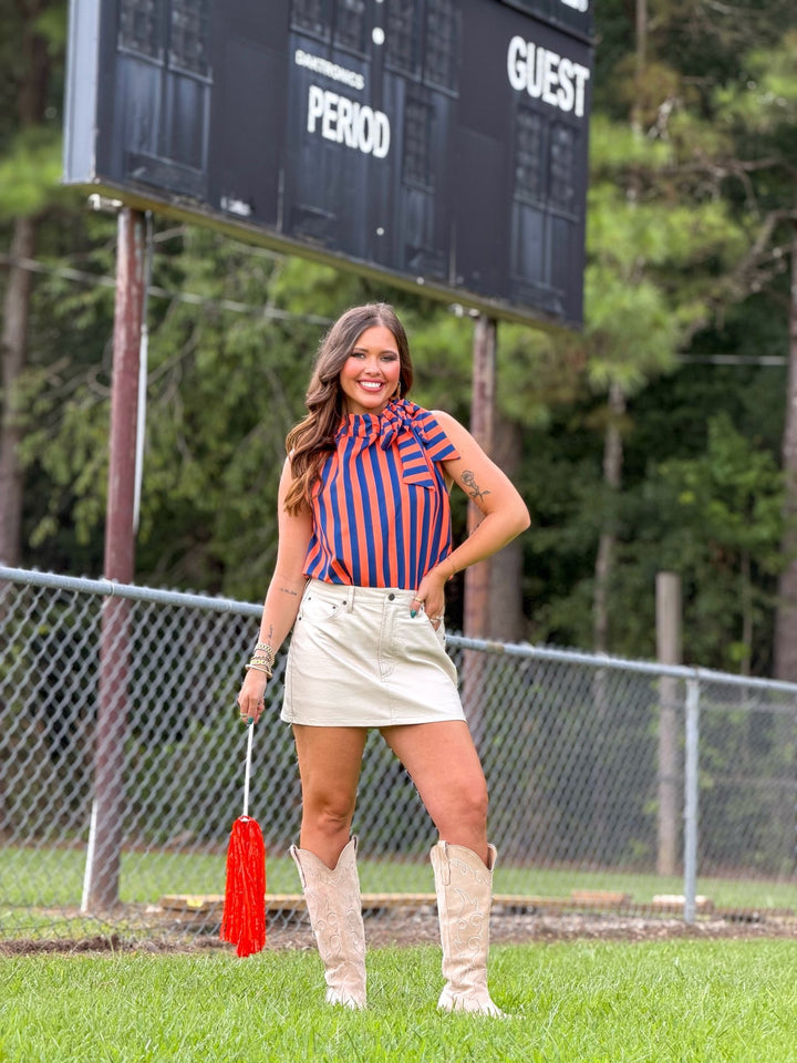 Navy sleeveless top with a ruffled tie neck