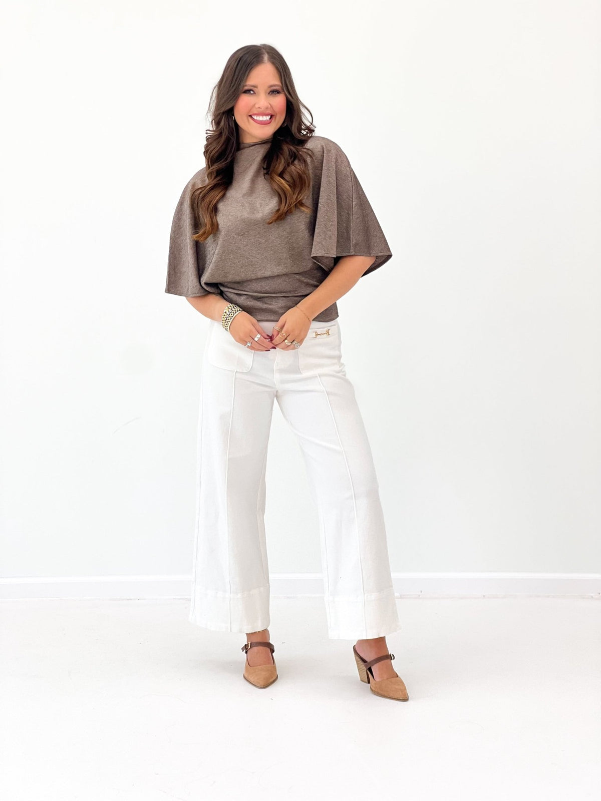 Brown top with wide flowing sleeves and a high collar