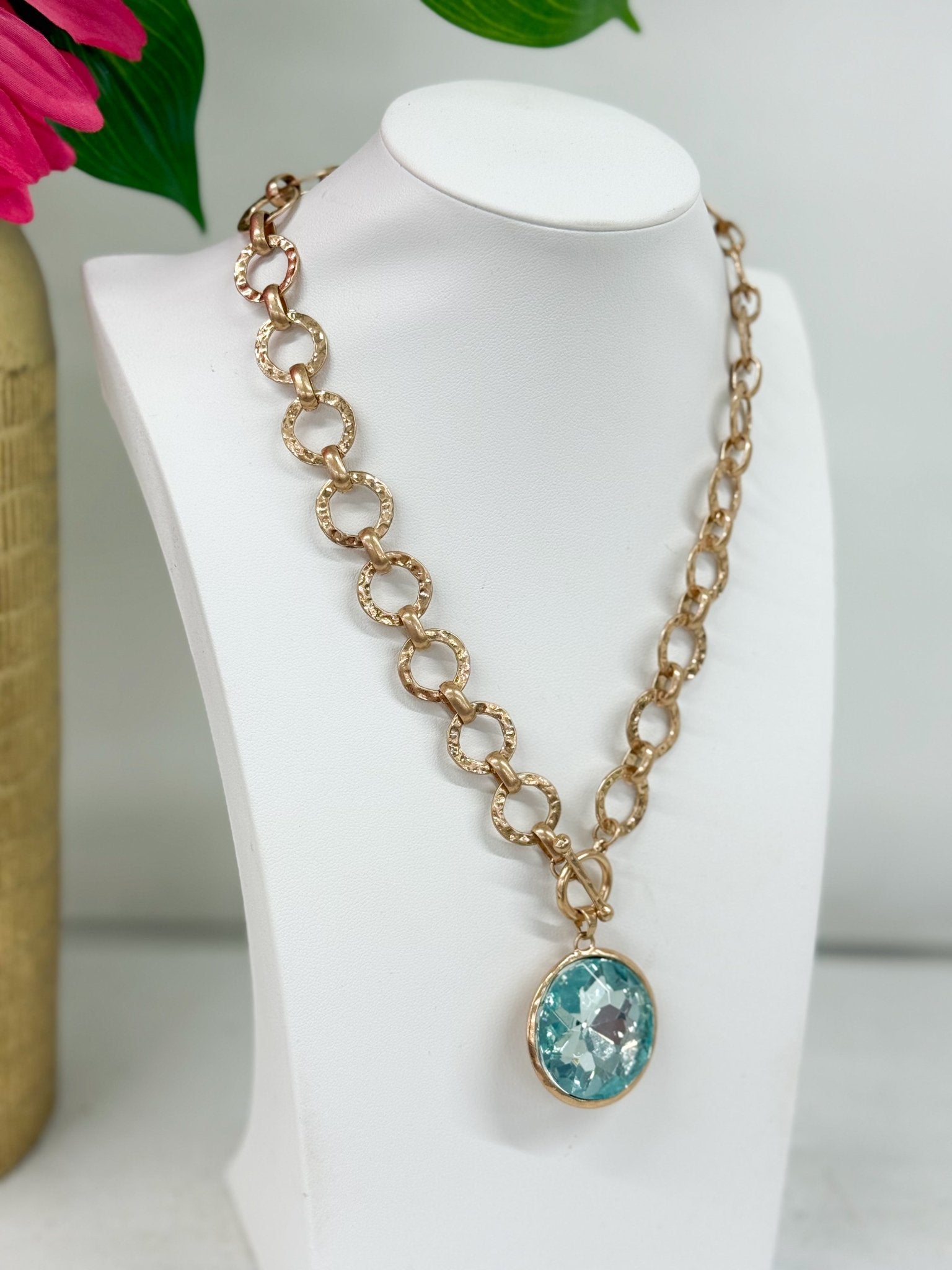 Glass pendant necklace with a gold-tone bezel
