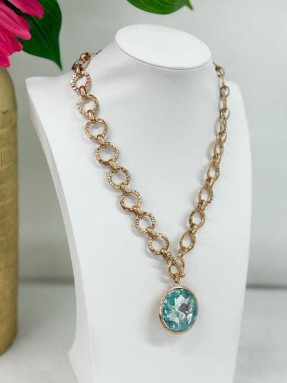 Glass pendant necklace with a gold-tone bezel