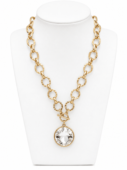 Round glass pendant on a gold chain necklace