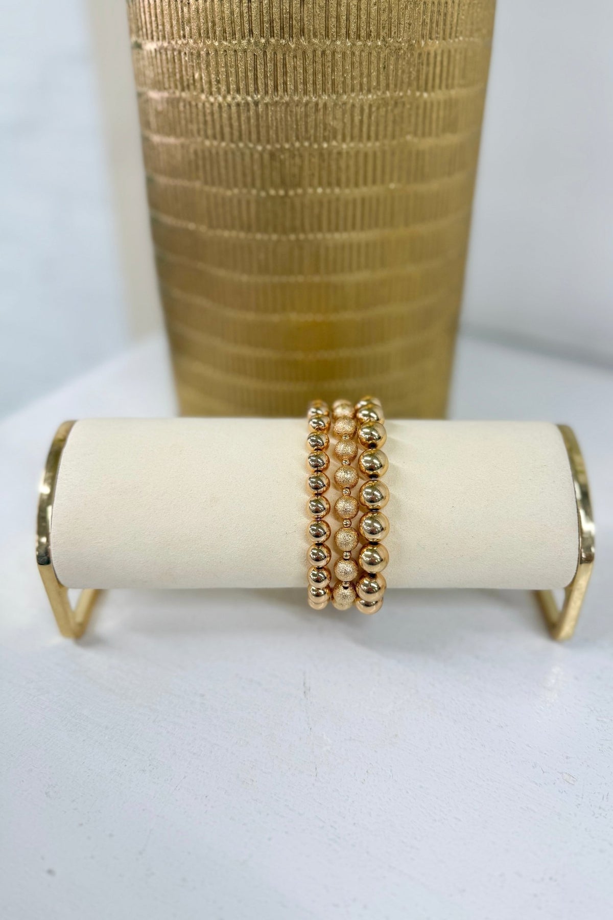 Gold three-row metal ball bracelet in mixed bead sizes
