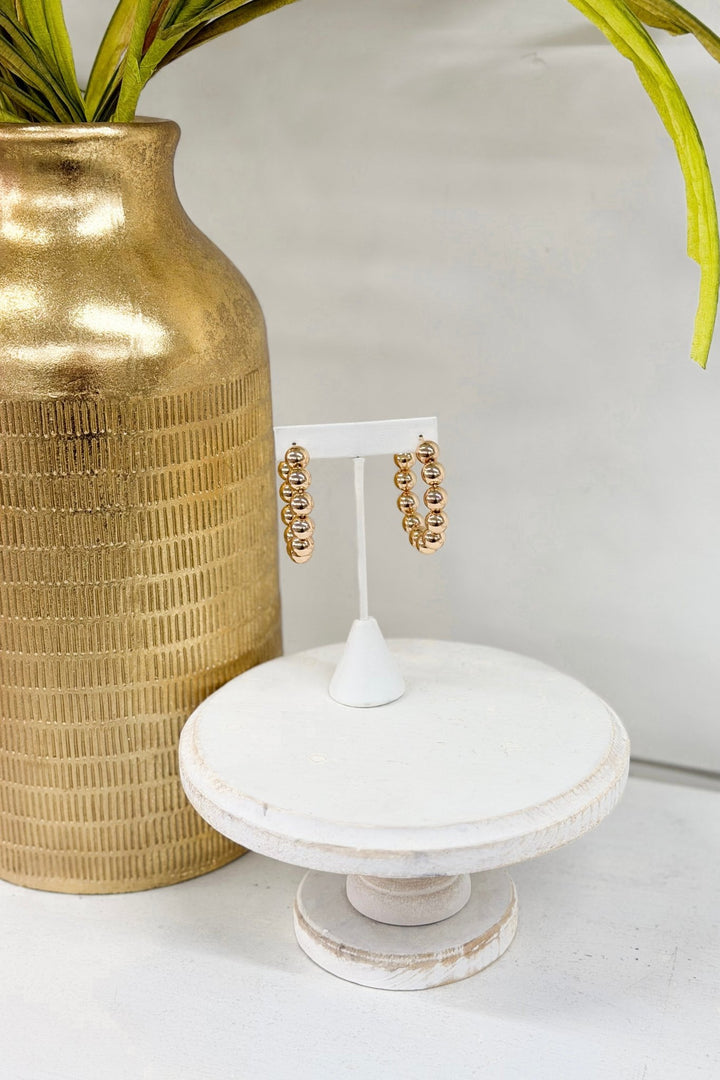 Gold 45mm hoop earrings strung with metal beads