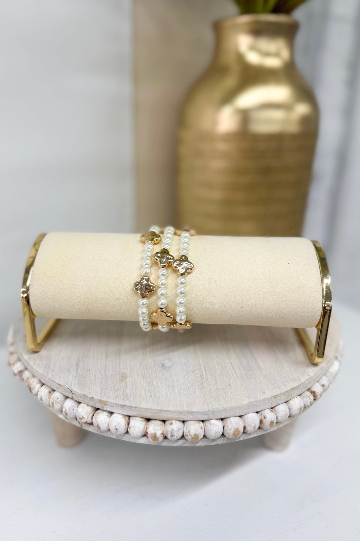 Three-row cream pearl bracelet with gold clover stations