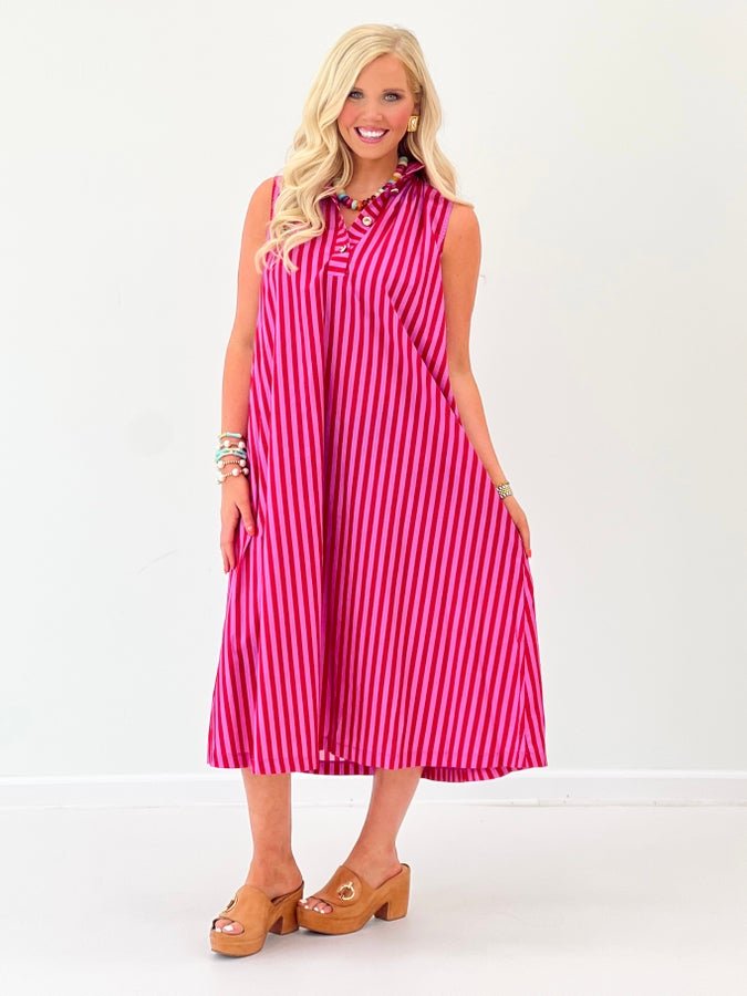 Sleeveless stripe dress falling to midi length with gold buttons
