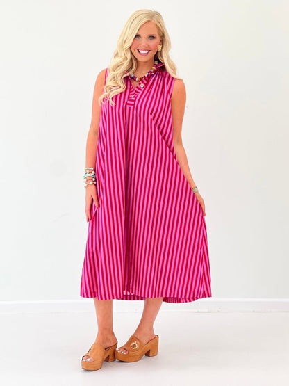 Sleeveless stripe dress falling to midi length with gold buttons