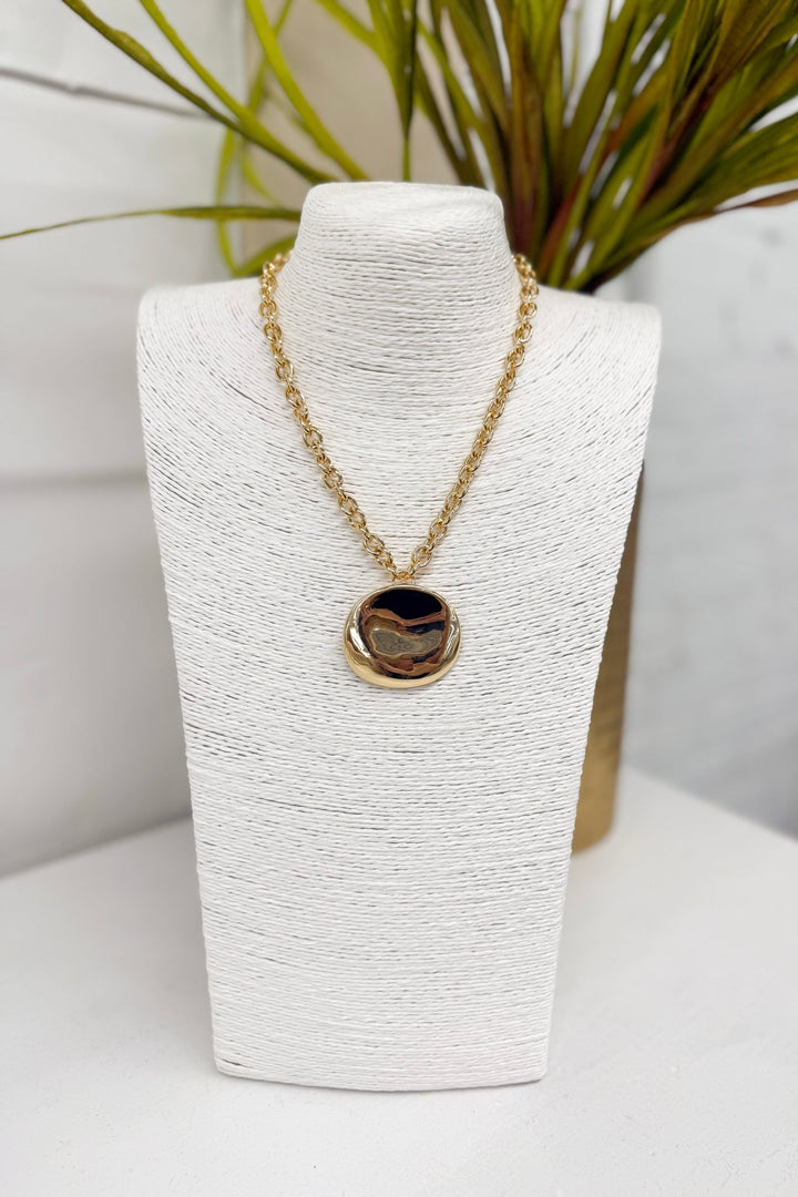 Gold disc pendant on a chain necklace