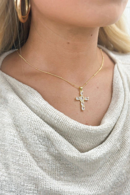 Cross charm on a delicate gold chain