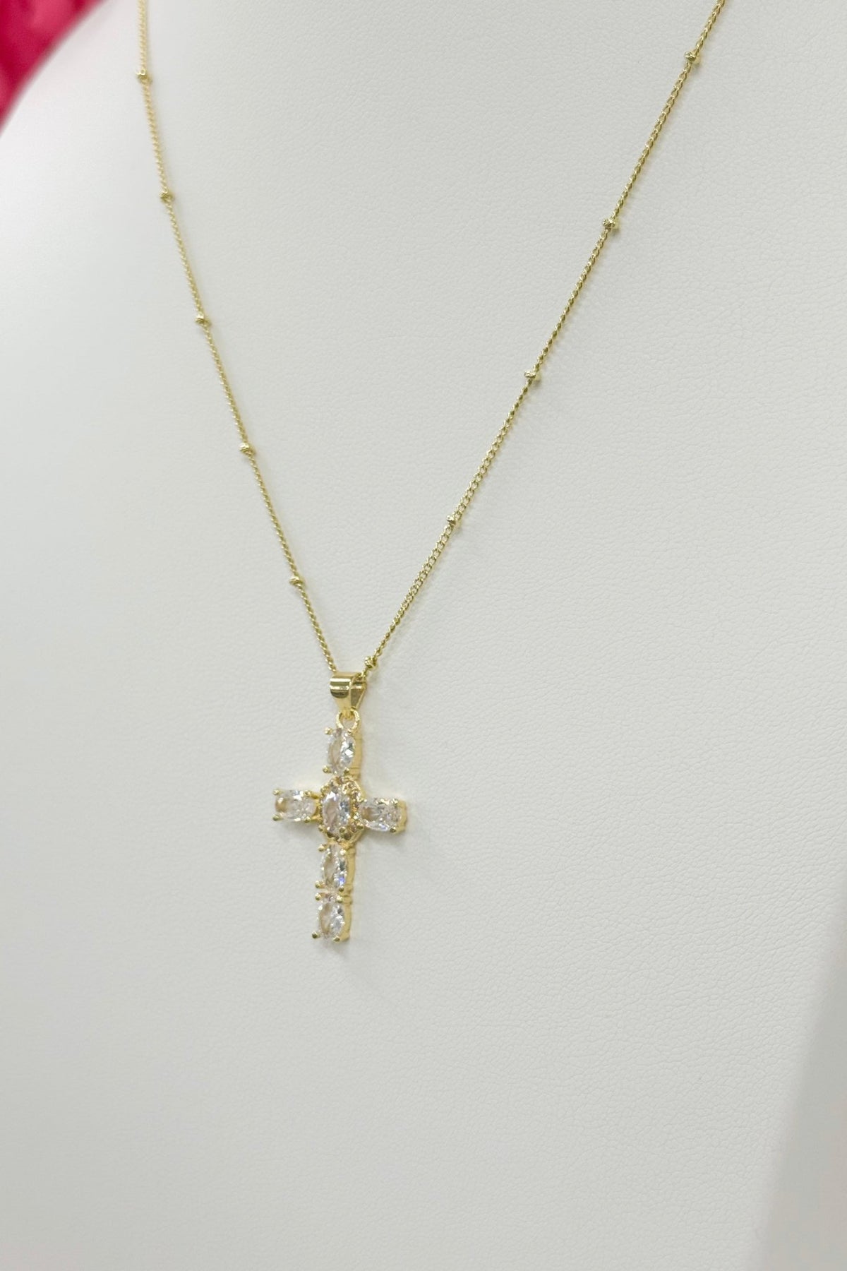 Gold cross necklace with a smooth finish
