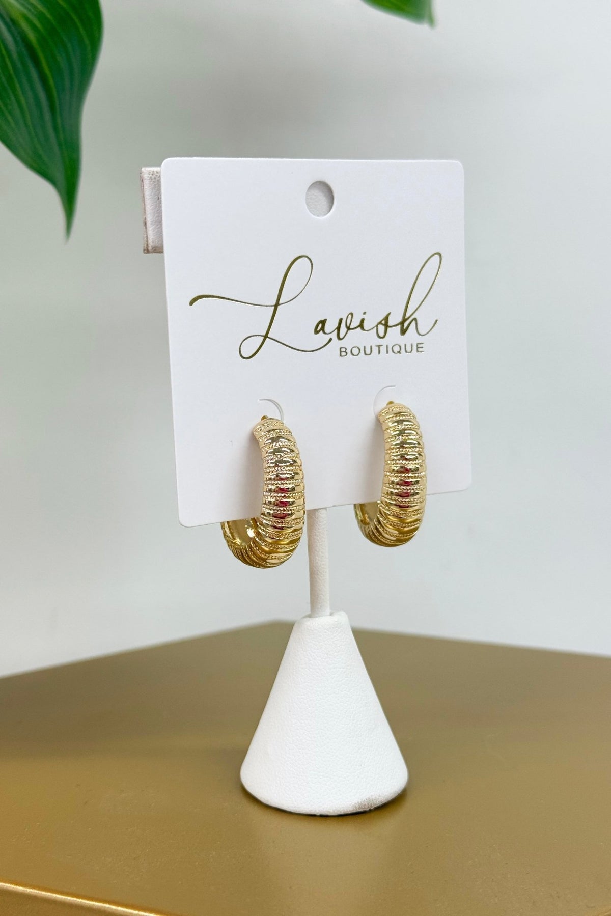 Curved gold hoops with an omega back