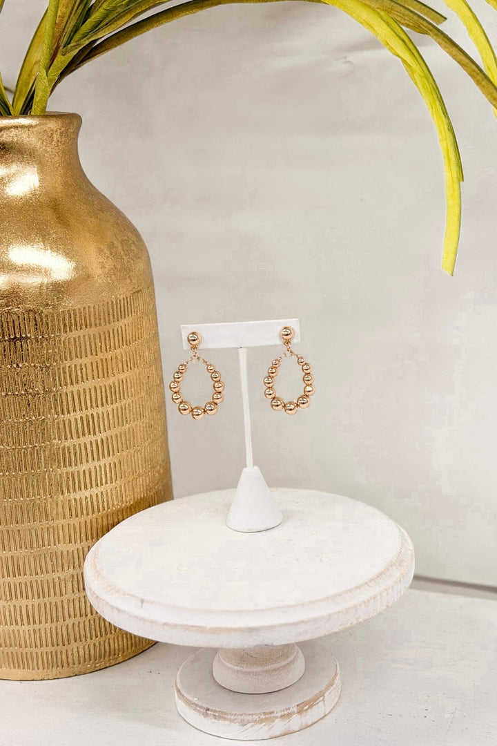 Gold teardrop earrings with graduated ball beads