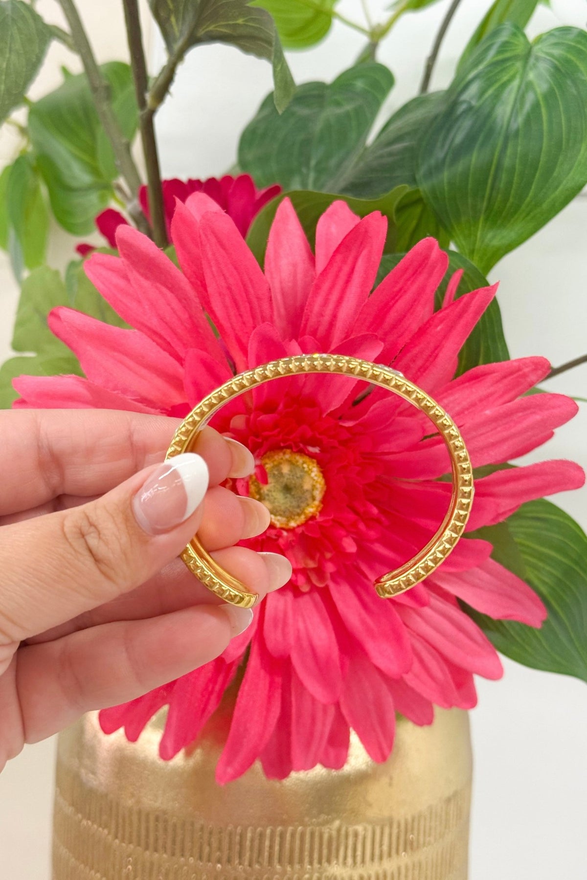 Sparkling stone bangle in polished gold