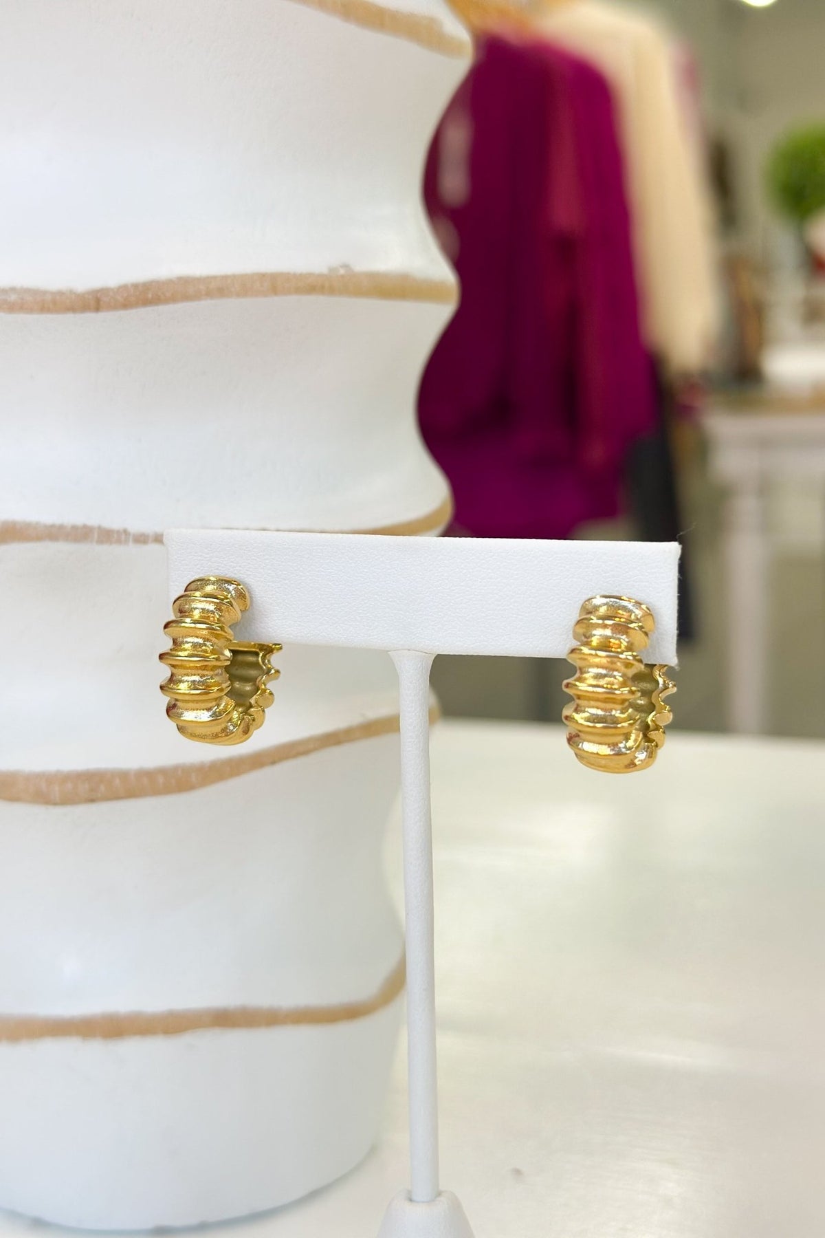 Gold hoop earrings with grooved detailing