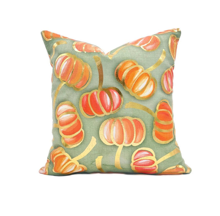 Golden orange velvet throw pillow with a falling pumpkins design
