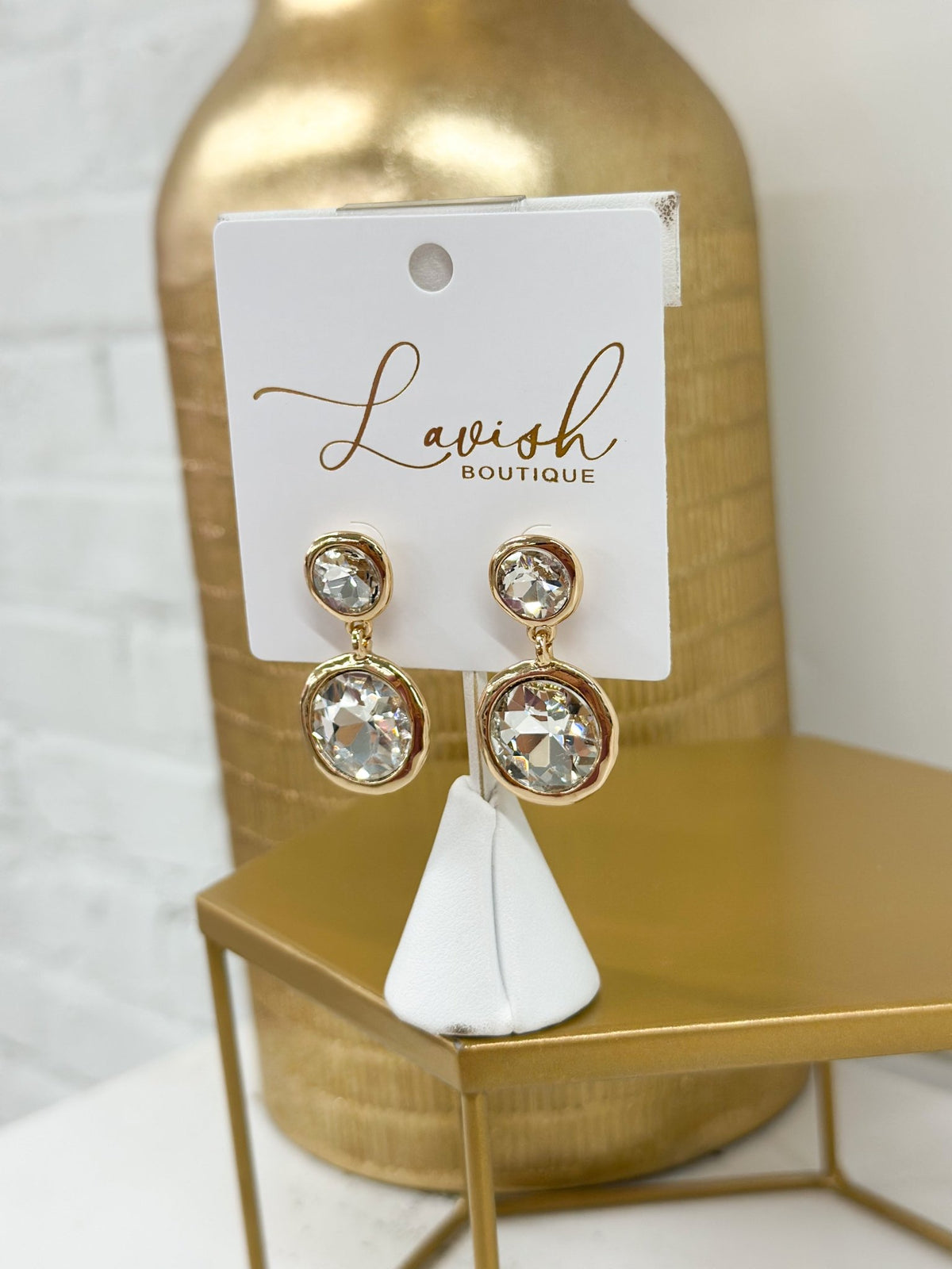Two-pearl dangle earrings with metal framing