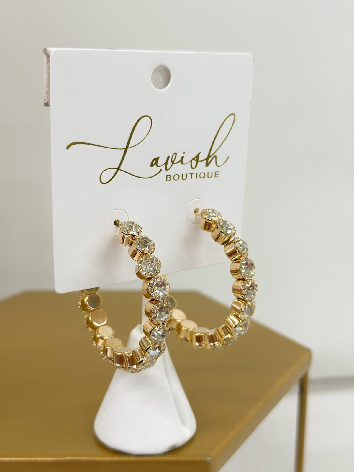 Gold hoops lined with faceted clear crystals