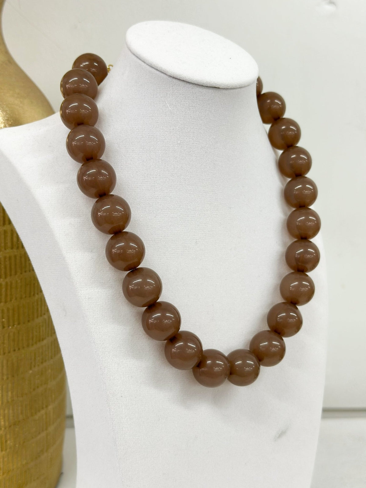 Round colored beads strung into a necklace