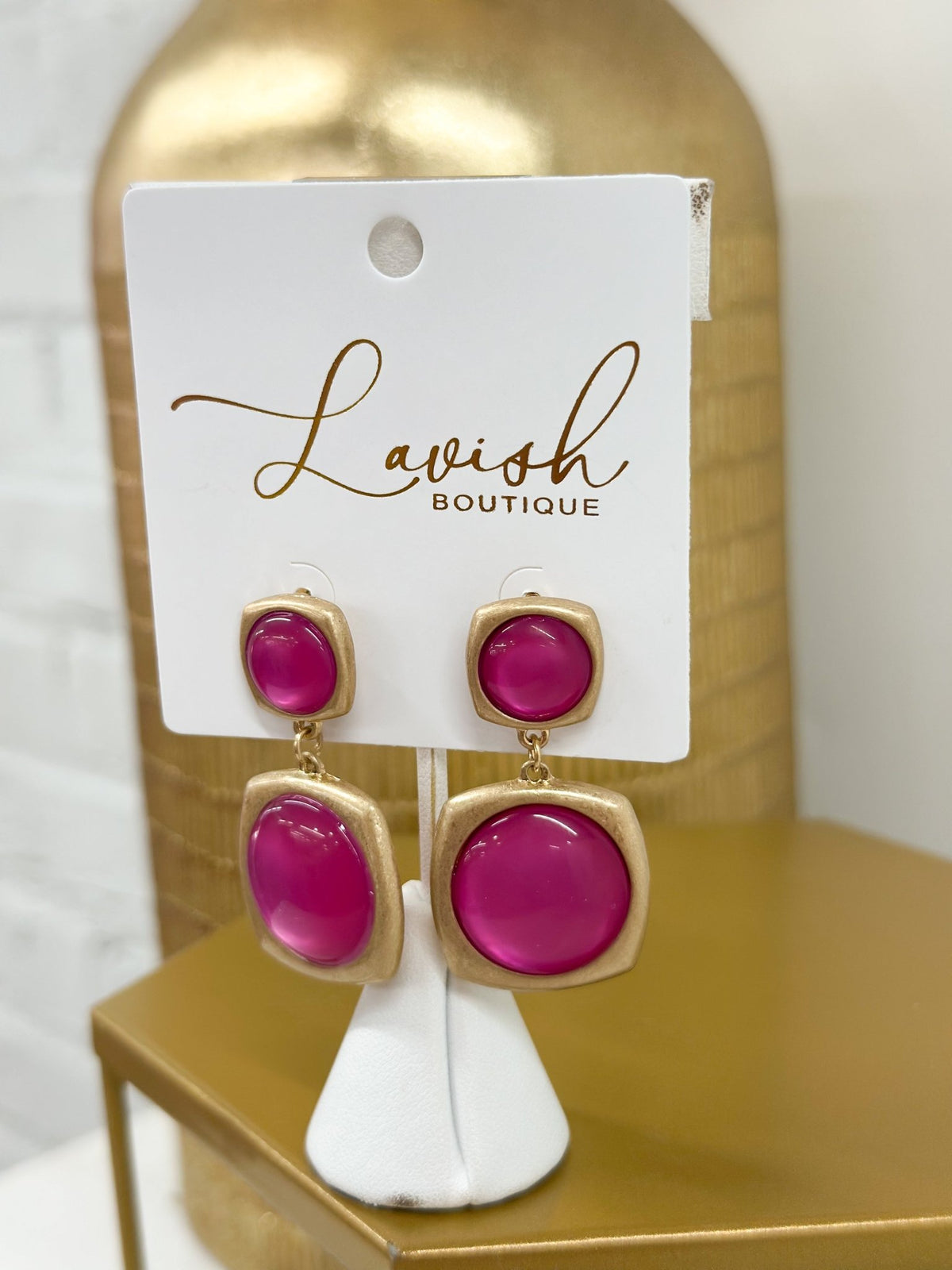 Gold earrings accented with hot pink stones