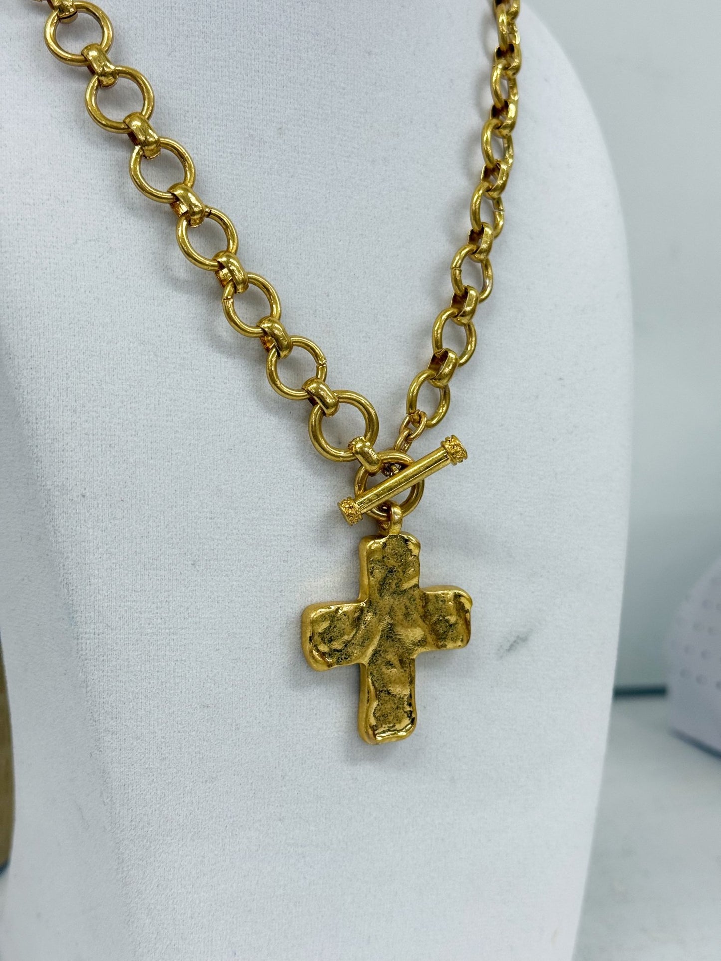 Gold chain necklace with a cross drop