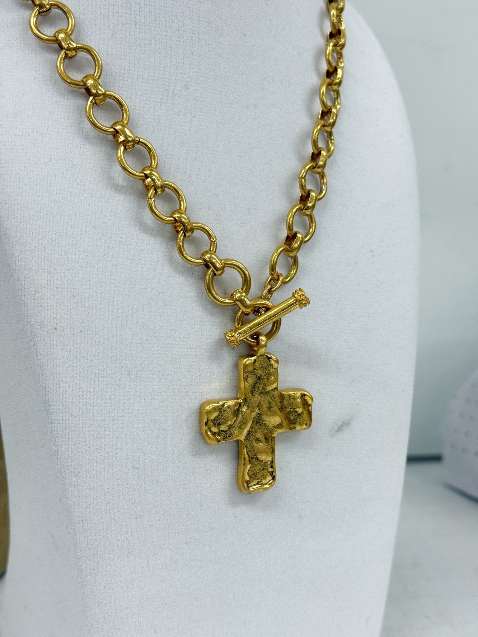 Gold chain necklace with a cross drop