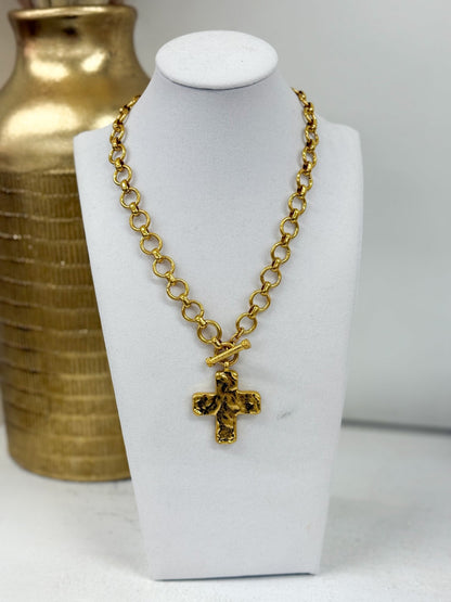 Gold cross pendant on a chain necklace