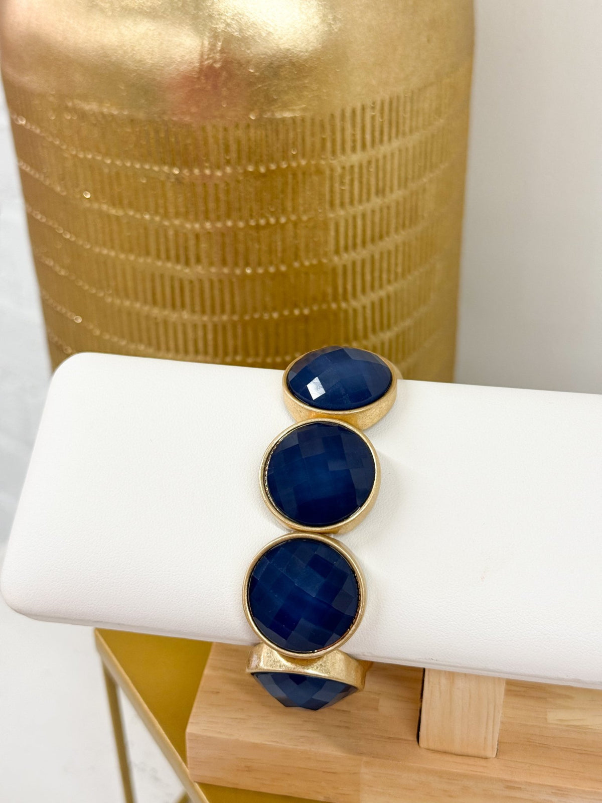 Faceted stone bracelet with a gold-tone accent