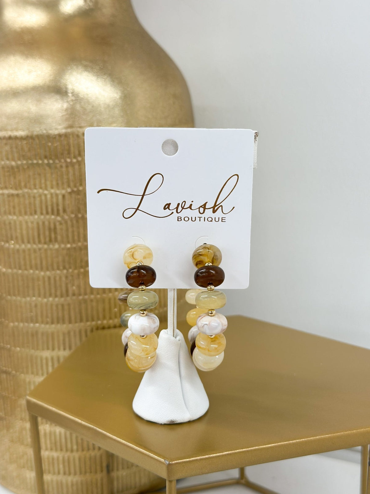 Gold hoops strung with beige marble beads