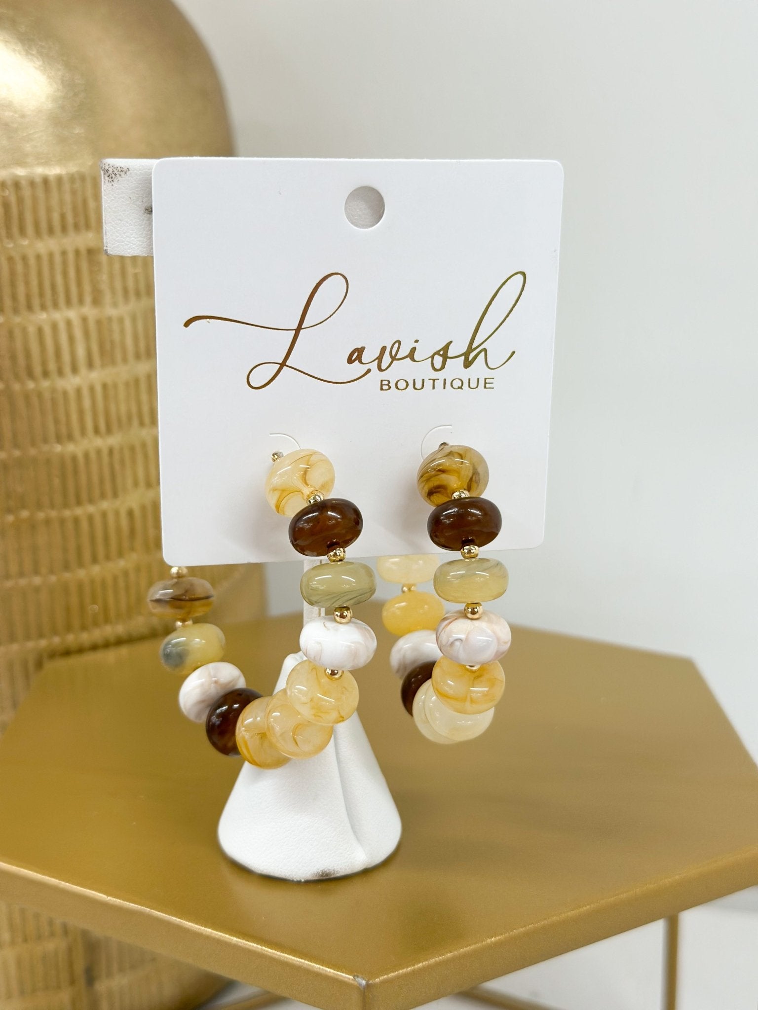 Marble beaded hoops in a soft beige tone