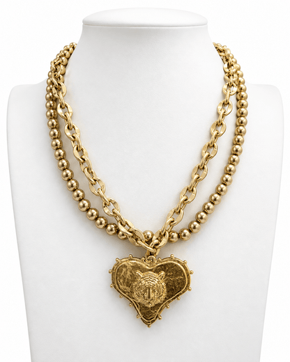 Heart pendant necklace layered with a team mascot charm