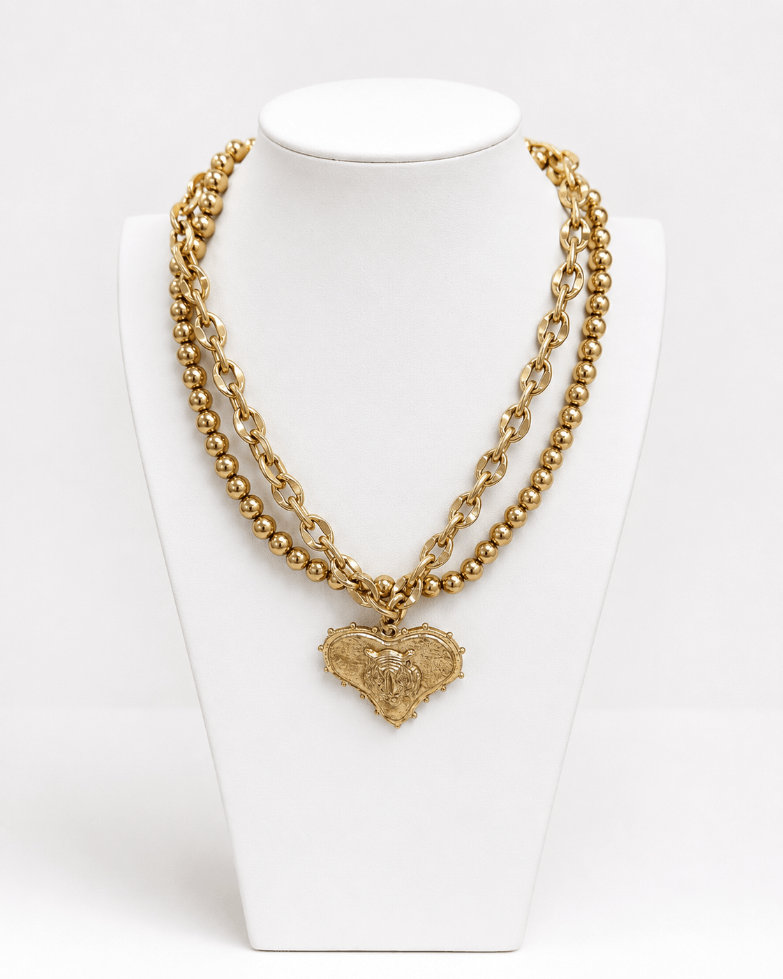 Two-strand worn gold necklace with heart and mascot detail