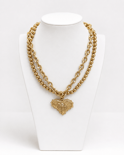 Two-strand worn gold necklace with heart and mascot detail