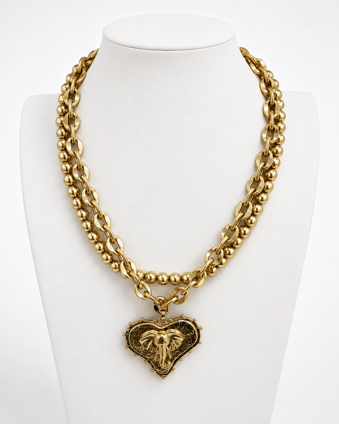 Worn gold layered chains with heart and mascot pendants
