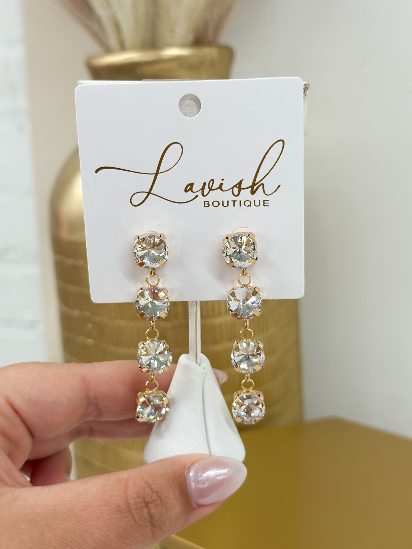 Gold earrings with a sparkling glass drop