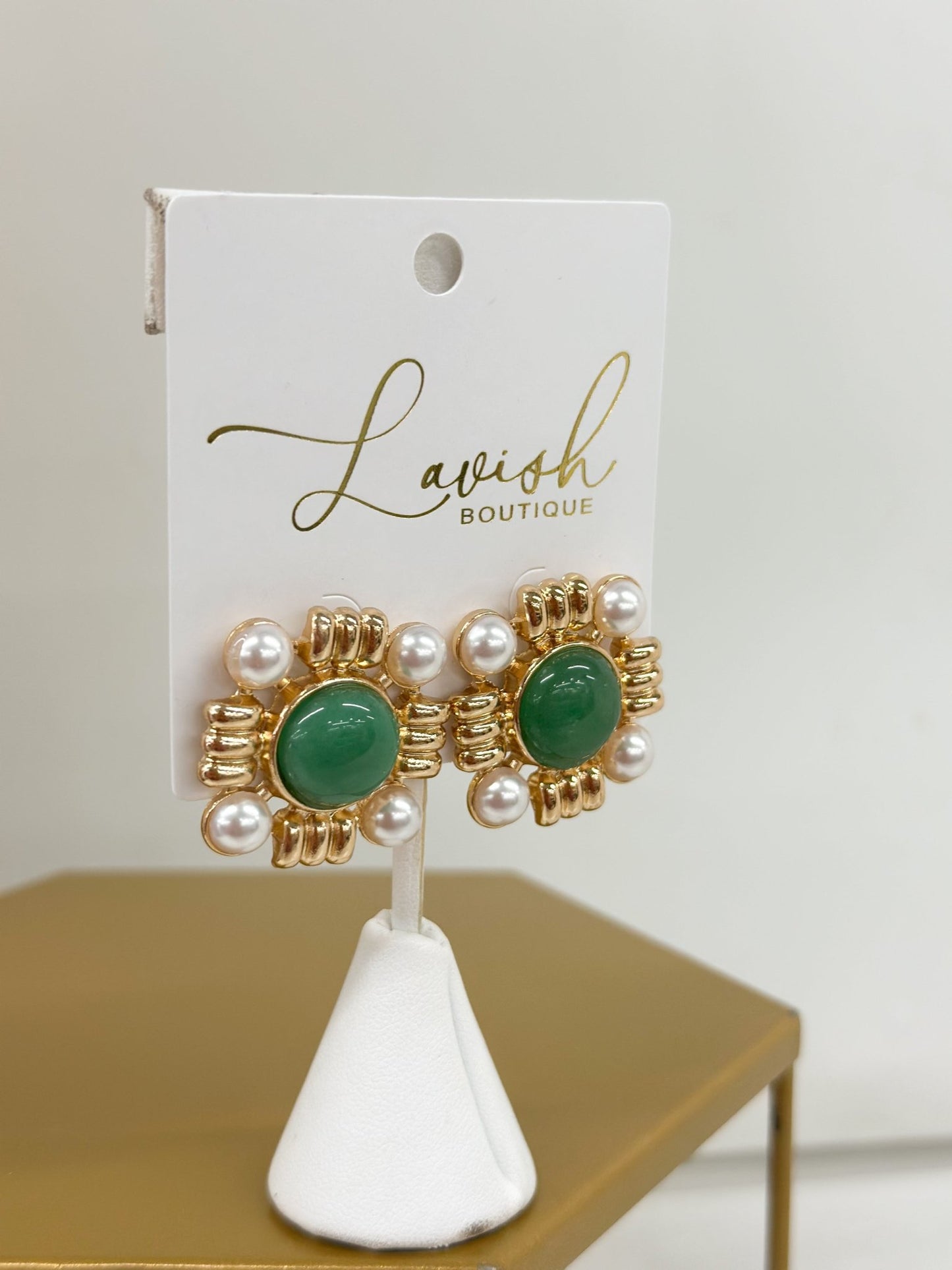Pearl drop earrings topped with a colored stone