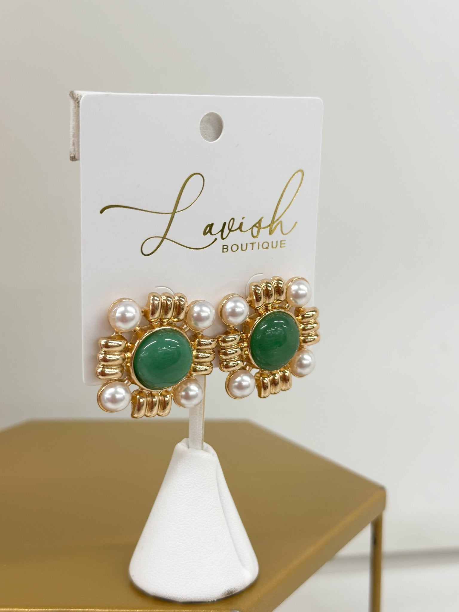 Pearl drop earrings topped with a colored stone