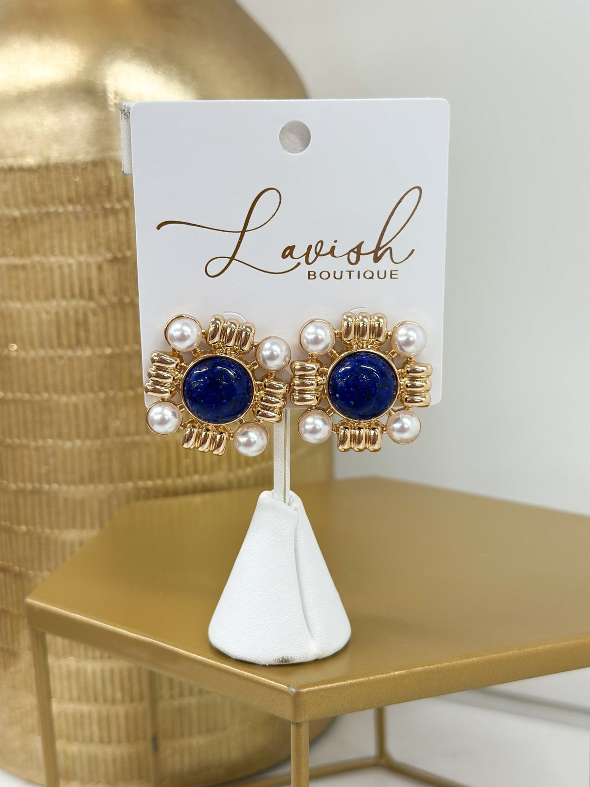 Gold earrings with a stone stud and pearl below
