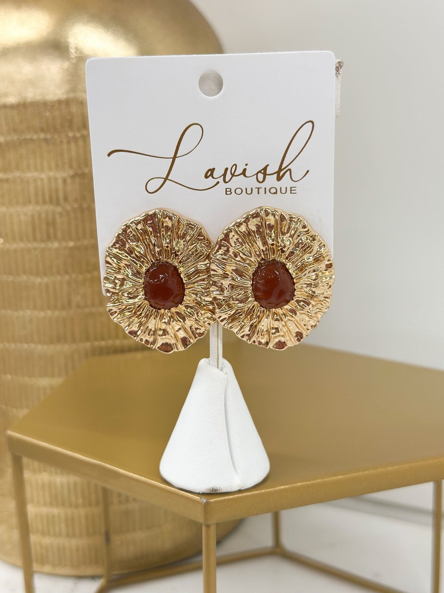 Gold earrings with a textured brown oval stone