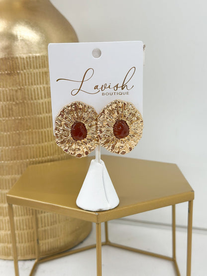 Textured brown ovals set in gold-tone metal