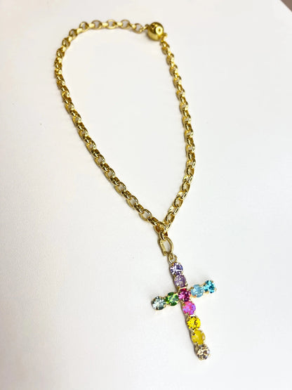 Confetti crystal necklace centered on a gold cross