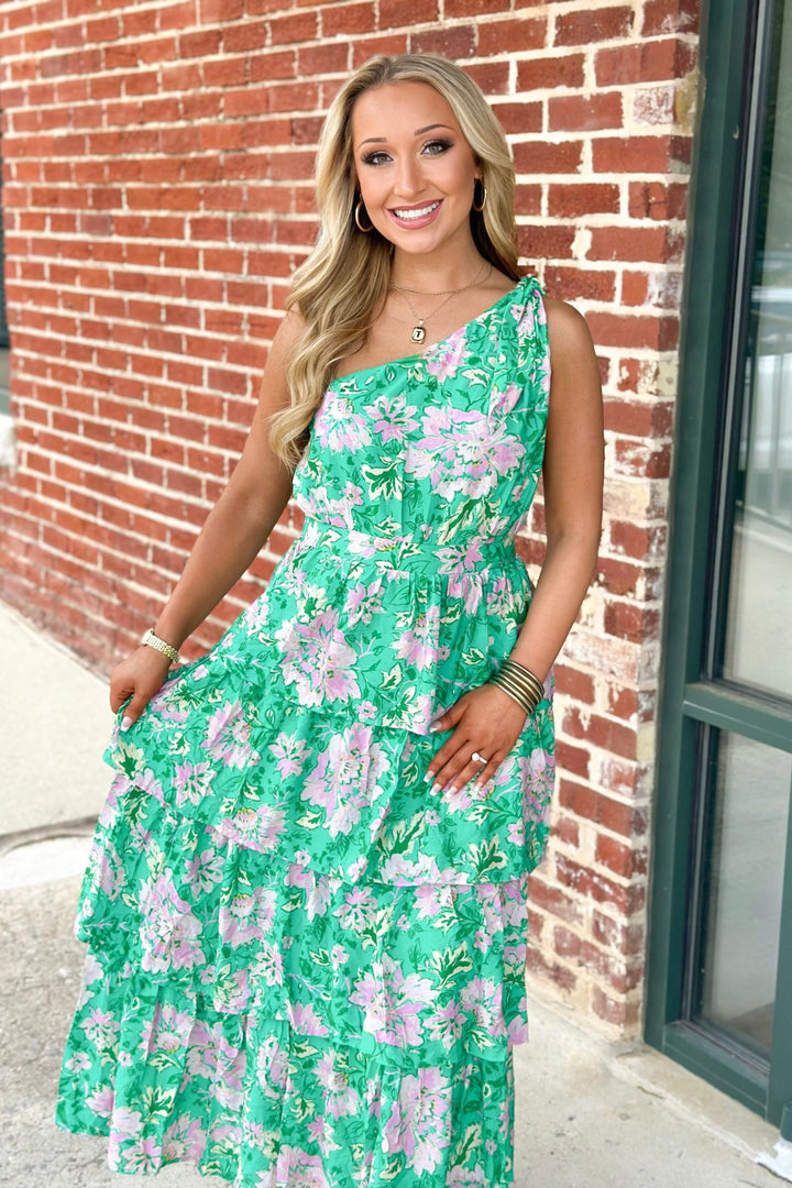 Green tiered dress with an asymmetric one shoulder sleeve