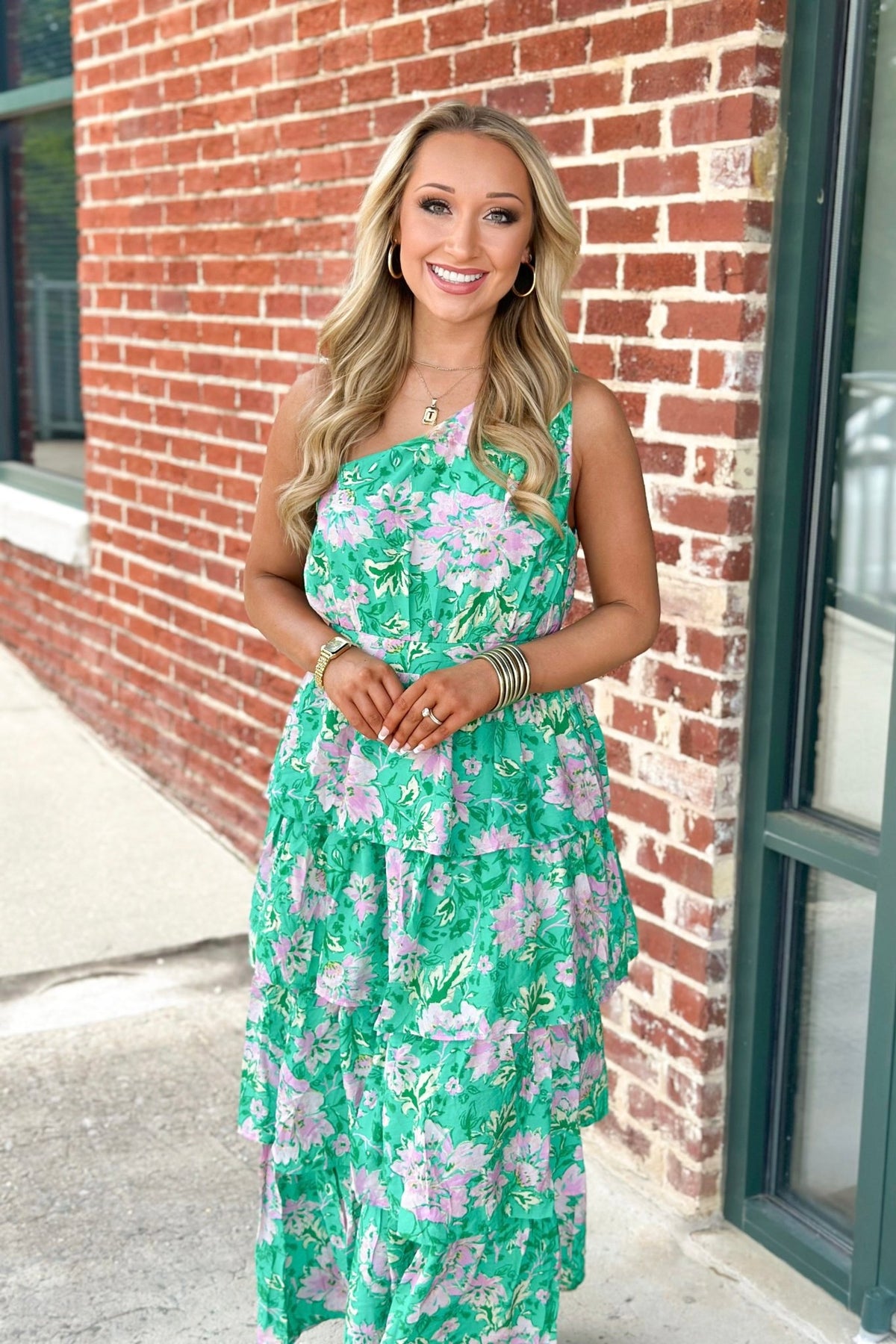 Flowy tiered skirt on a lined green one sleeve dress