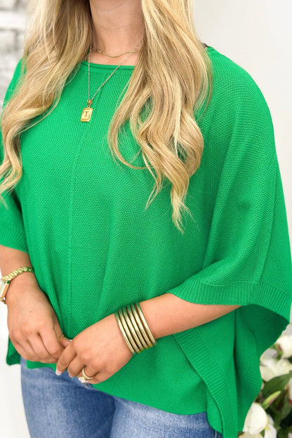 Loose green knit with dramatic batwing shaping