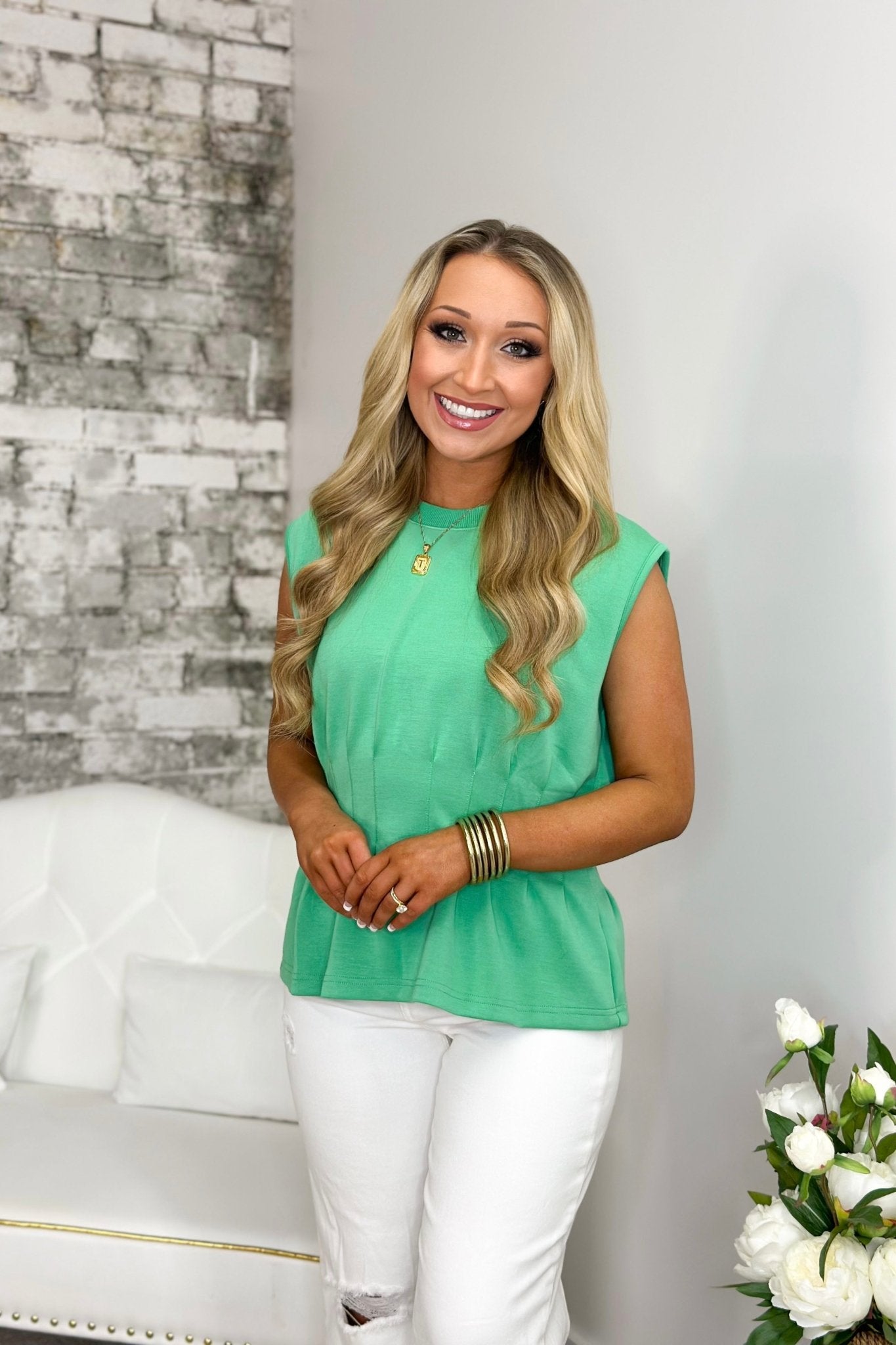 Pleat detail sleeveless top with a flared hem