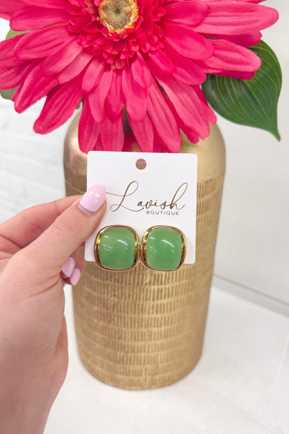 Star-shaped green stone studs in gold settings