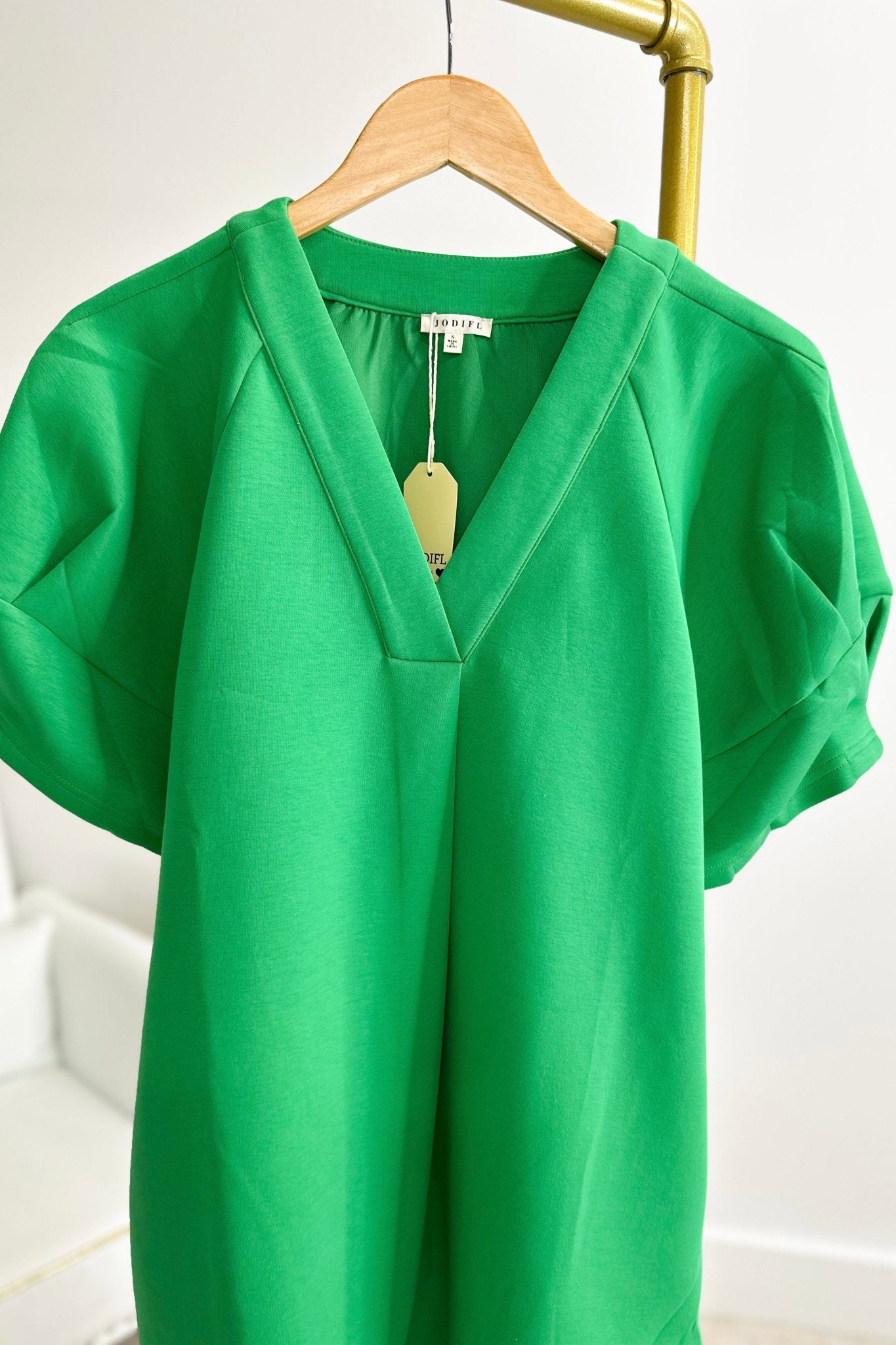 Kelly green V-neck dress with a flowing skirt